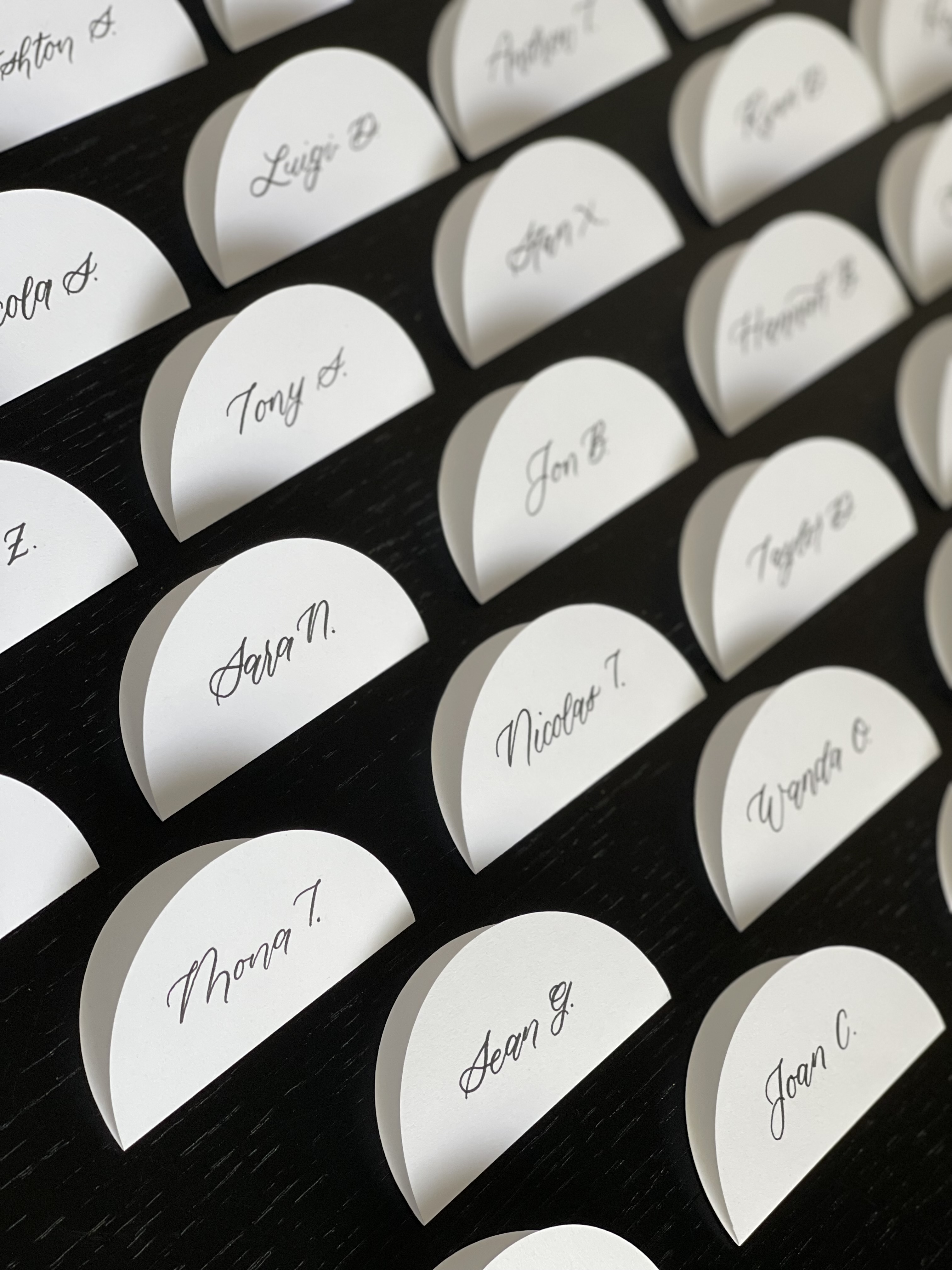 Hand-lettered place cards arranged in rows