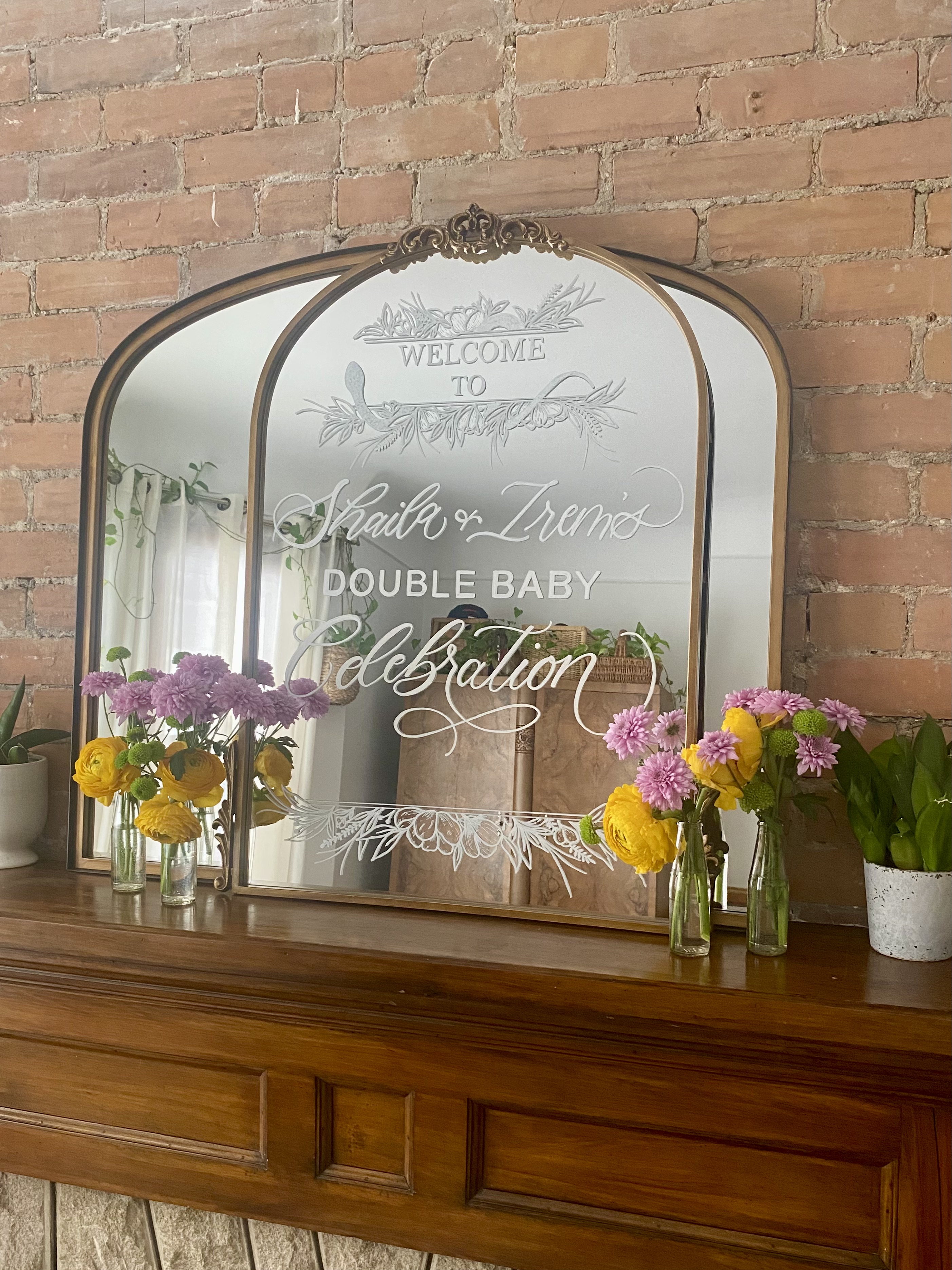 Mirror calligraphy sign with floral arrangement